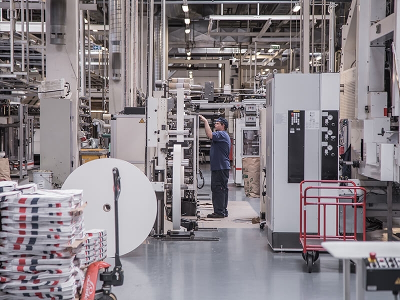 Technician maintaining automated packaging machinery