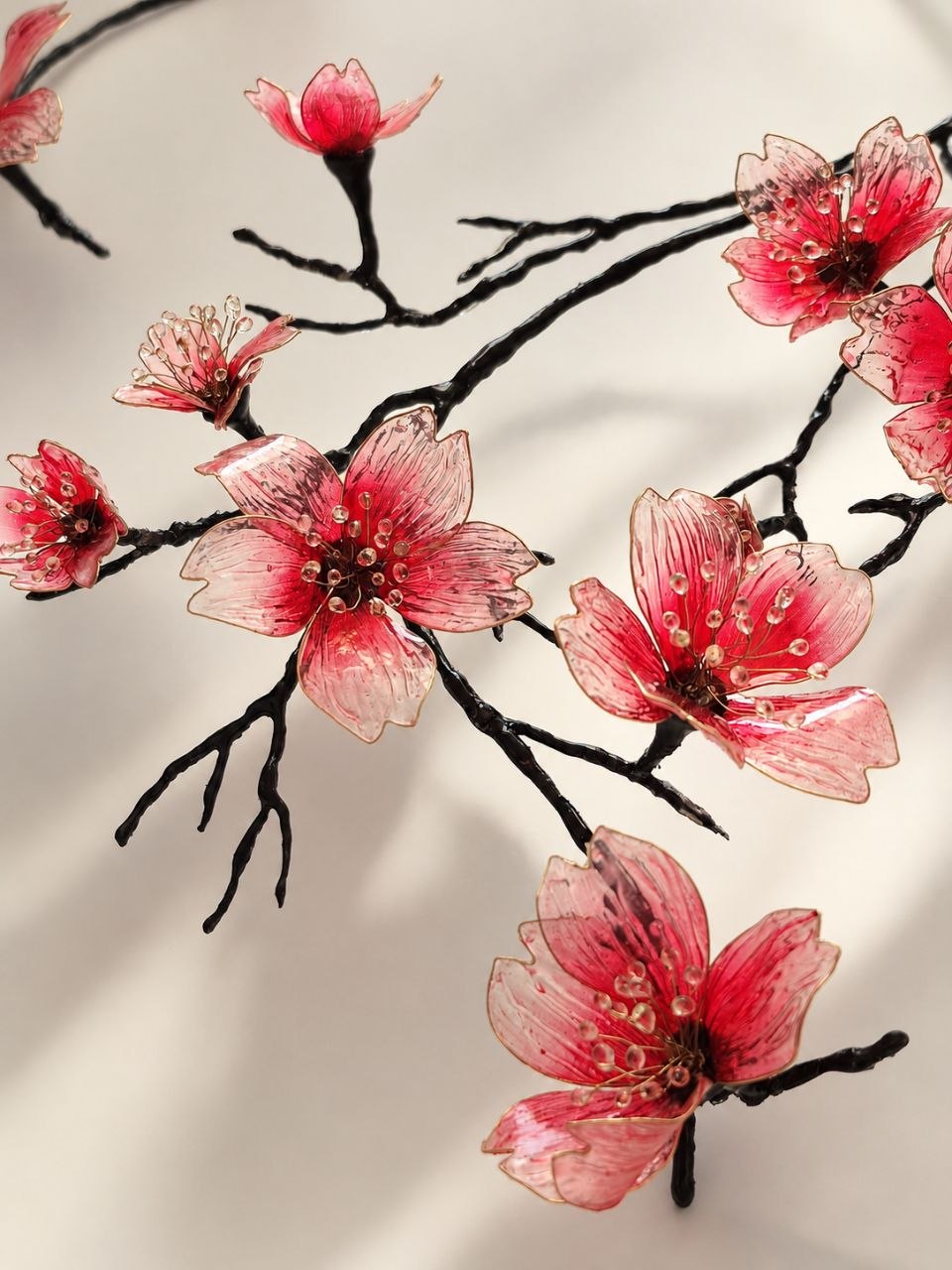 Macro view of glass Sakura flowers and black branches
