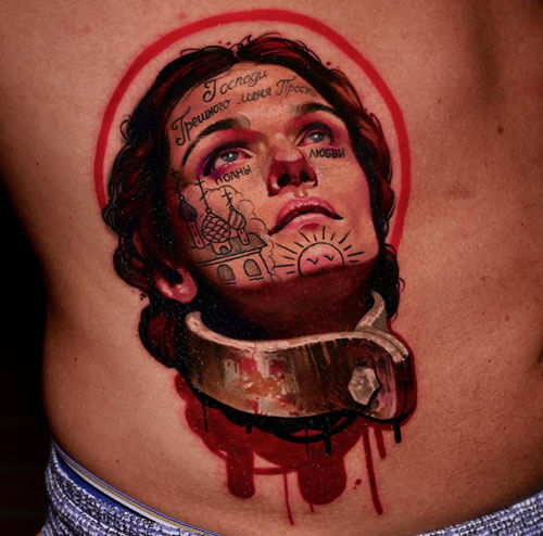 A tattoo artist from Los Angeles; a tattoo featuring a portrait of a woman in shackles, with Russian text on her face, a red halo, a metal ring around her neck, and dripping blood effects on her torso; by Andrei Kolbasin, 985