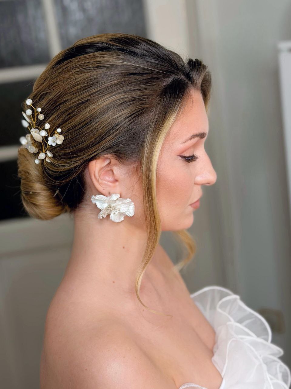 Bride wearing sculptural floral earrings
