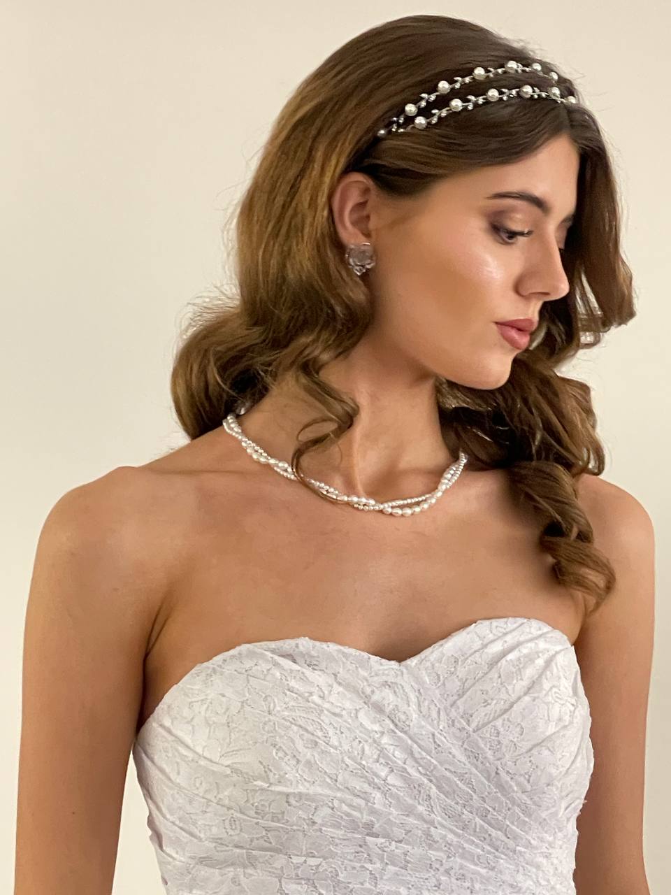 Bride in a strapless dress wearing pearl jewelry