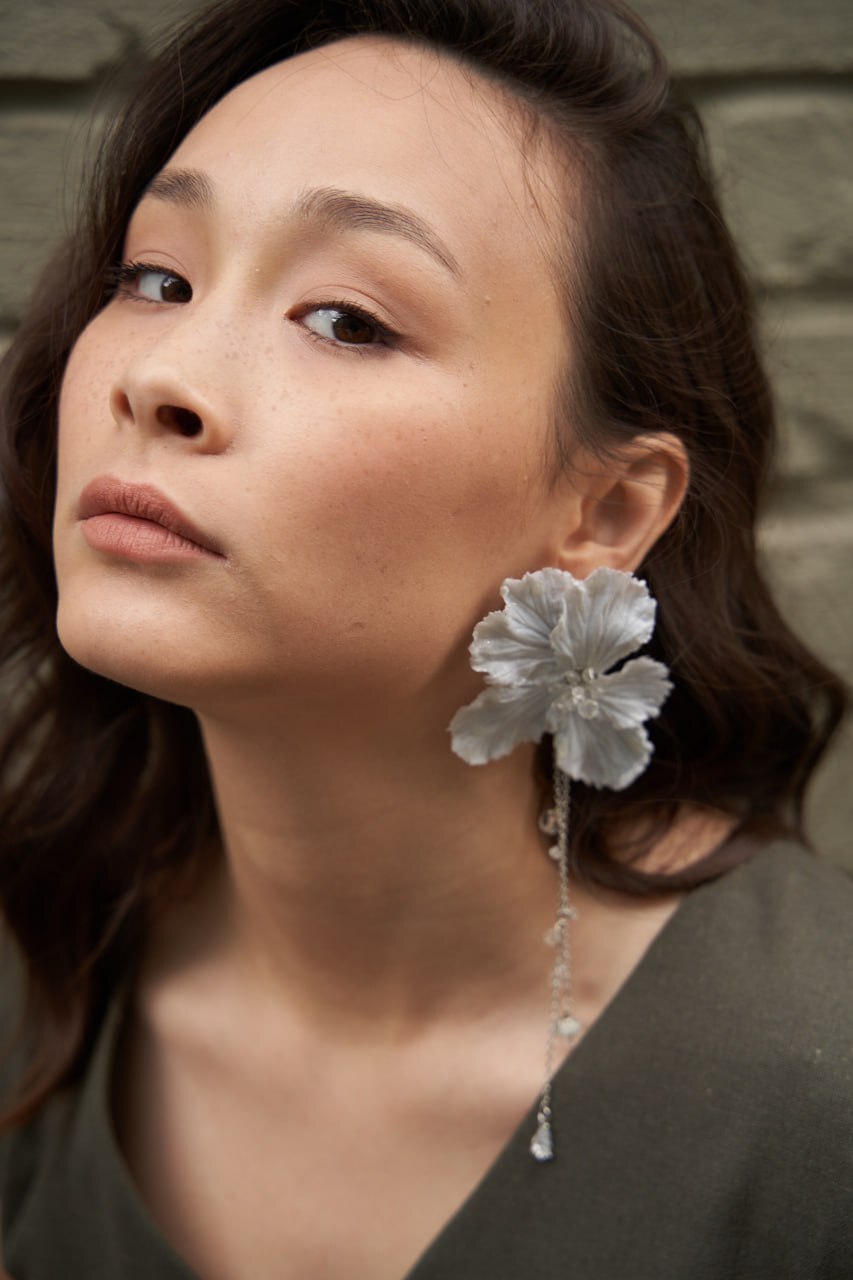 Woman wearing a statement flower earring
