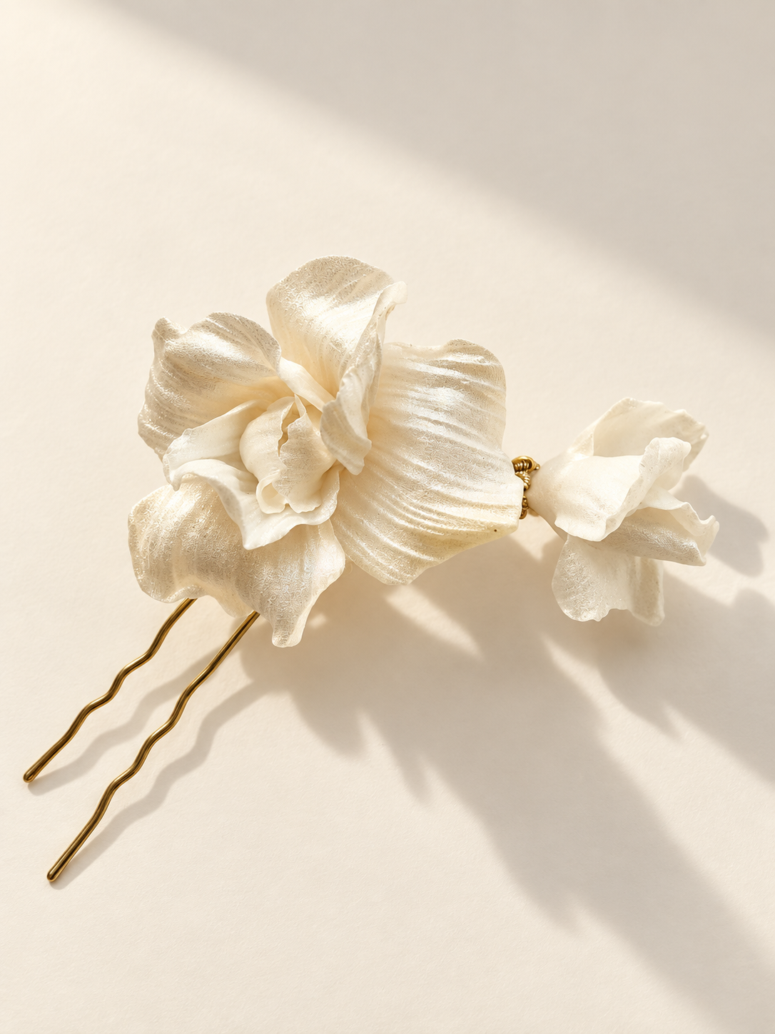 Ivory floral hair comb with a sculptural shadow