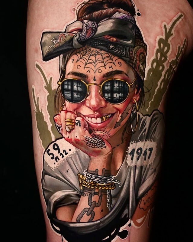 A tattoo artist from Los Angeles, a tattoo depicting a smiling Lady Gaga with gold teeth and jewellery, rings, chains and bracelets, wearing round sunglasses, with a headscarf, a spider’s web pattern on her forehead, and tattoos on her arms; by Andrei Kolbasin, 999
