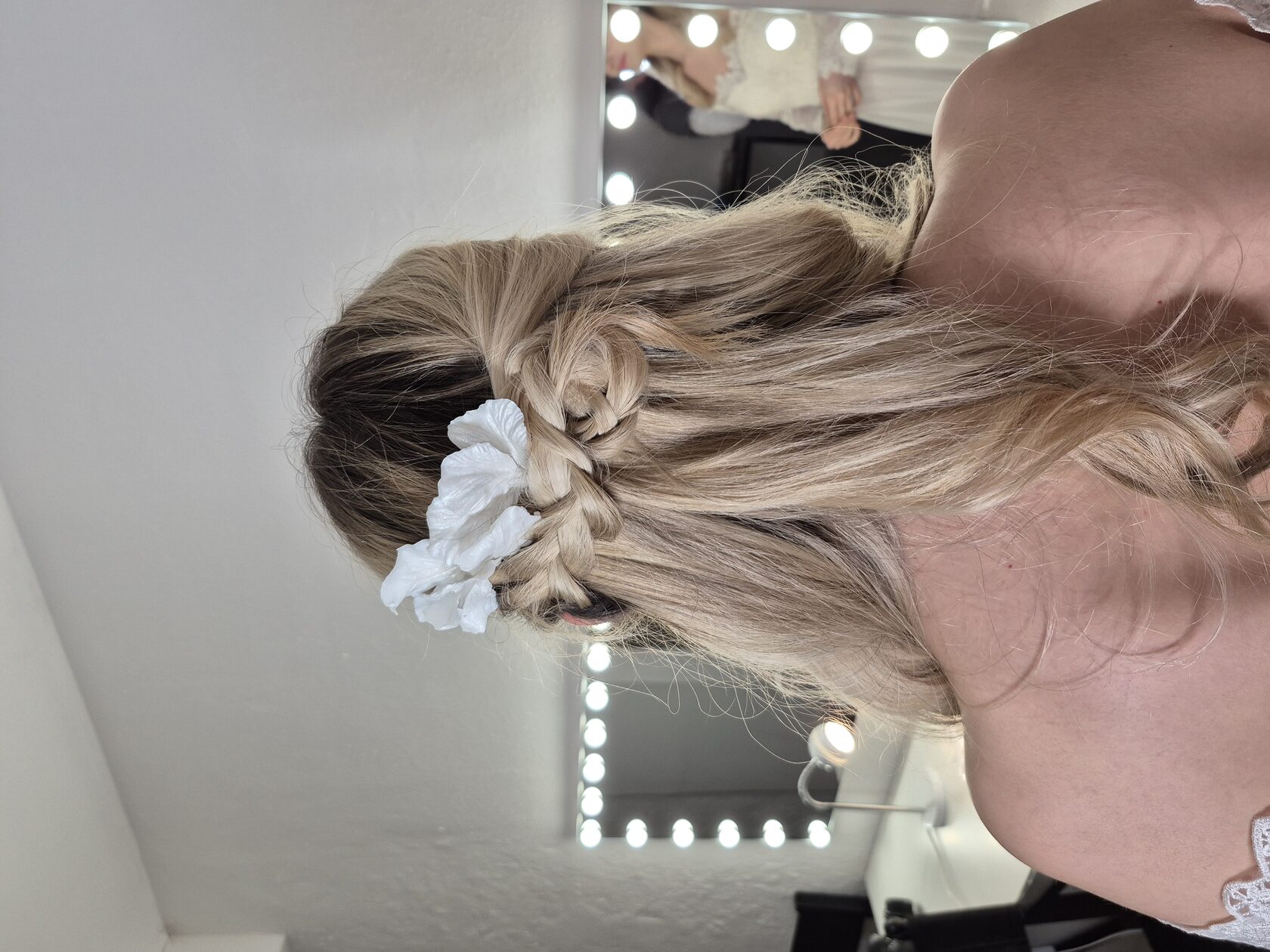Model wearing Yoli floral jewelry in the dressing room